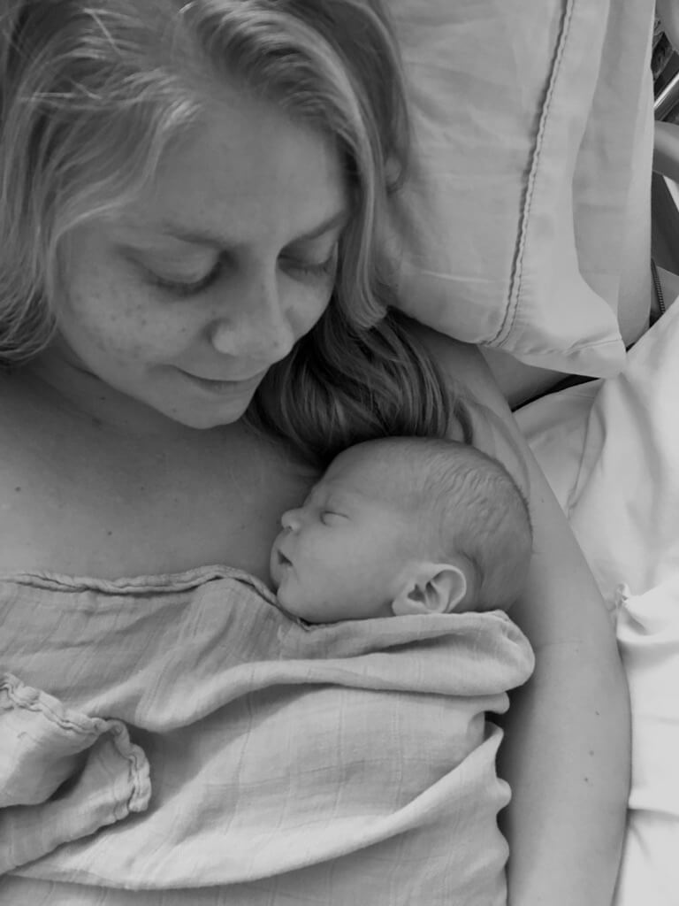 black and white image of new mom in hospital bed with newborn son on chest for 3 things I wish I had known as a new mom post