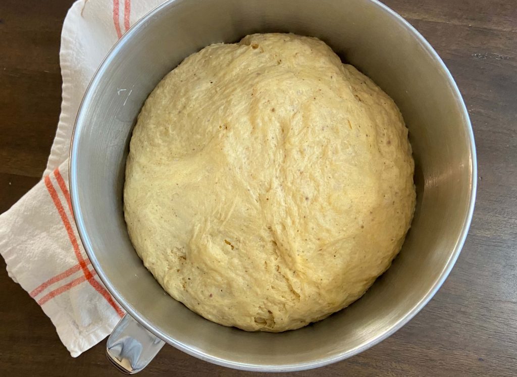 bagel dough in bowl after overnight rise
