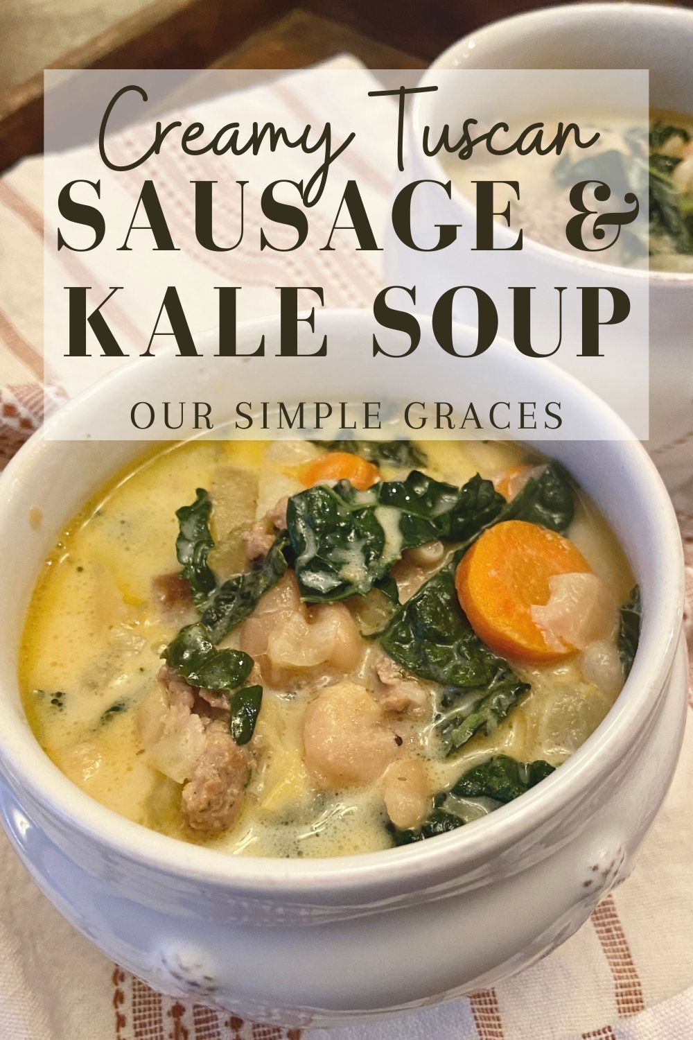 image of two soup bowls on kitchen table filled with zuppa toscana and text over image with words creamy tuscan sausage and kale soup by our simple graces