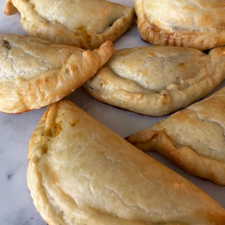 image of pumpkin pasties and apple hand pies on white marble surface