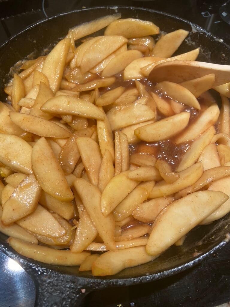 image of sliced apples simmering in saucepan with butter and brown sugar