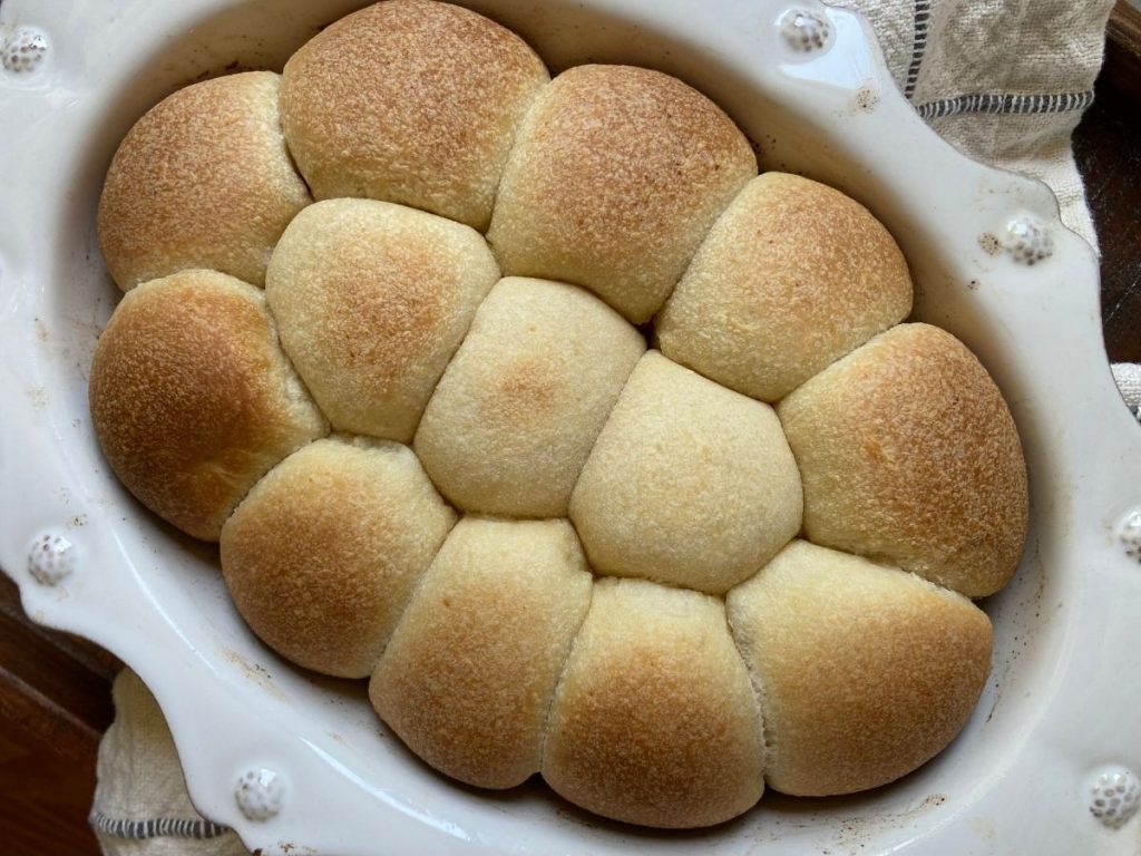 sourdough rolls in white baking dish after being baked