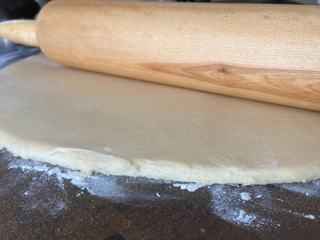 rolled out dough with rolling pin on top