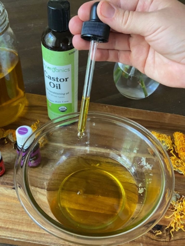 vitamin e drop into bowl of oil on cutting board