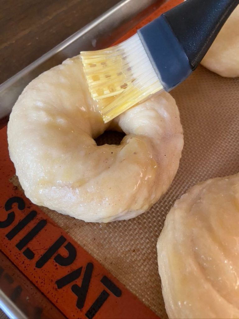 brushing butter with pastry brush on bagels