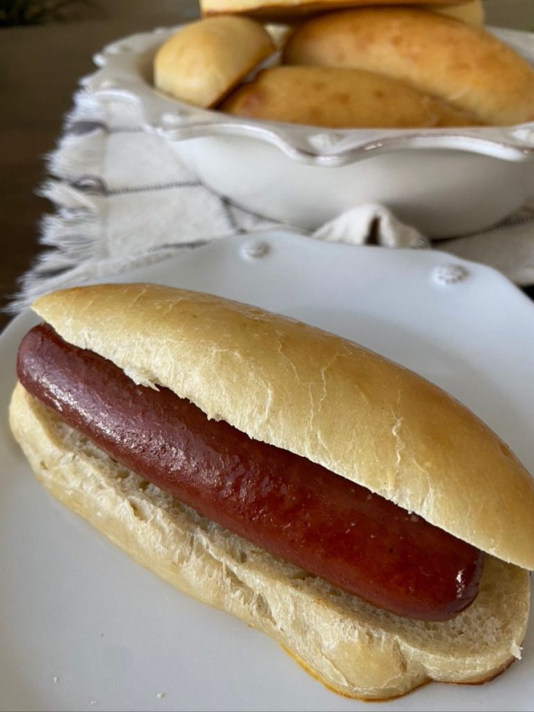 sourdough hot dog bun with hot dog on plate